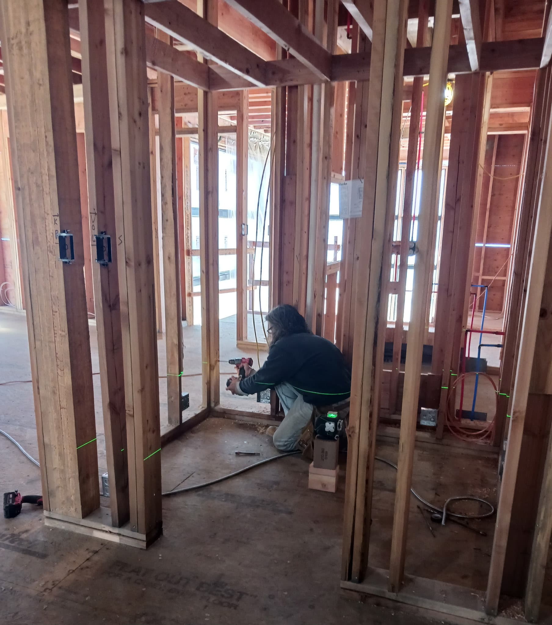 Interior framing and early site preparation for sauna work.
