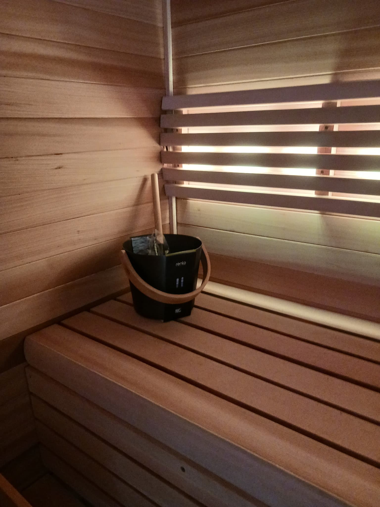 Sauna heater and wood bench detail in a finished corner.